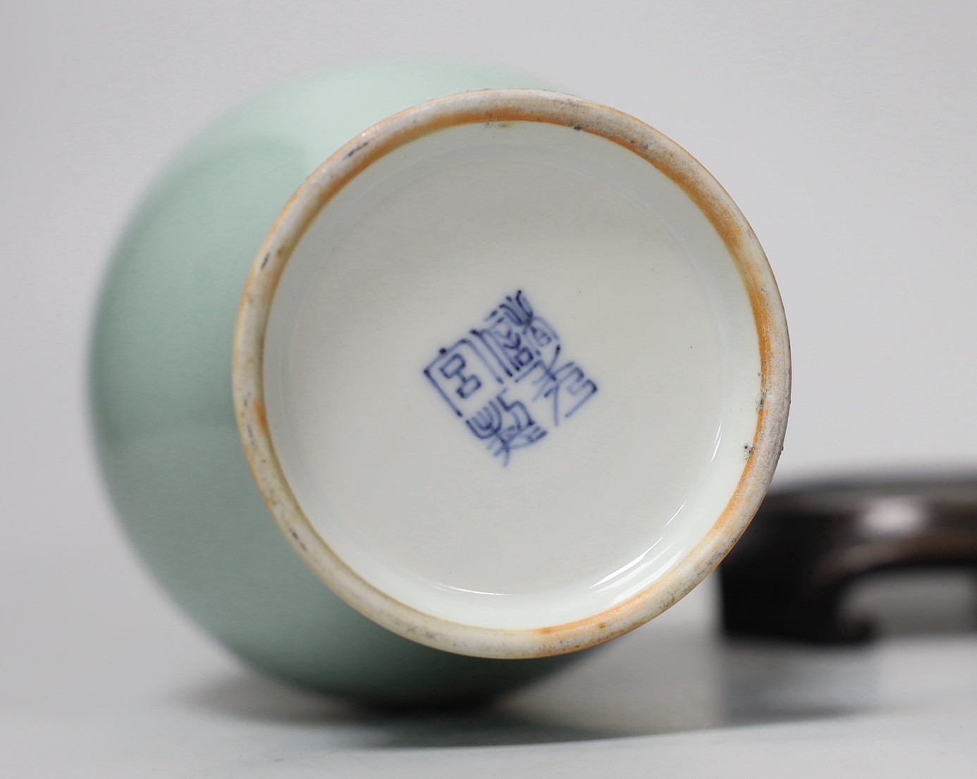 A Chinese celadon glazed vase, hallmark to base, wood stand. 24.5cm high